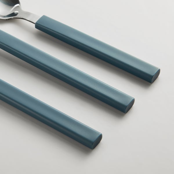 Three blue-handled utensils: spoon, fork, knife, set on white surface.