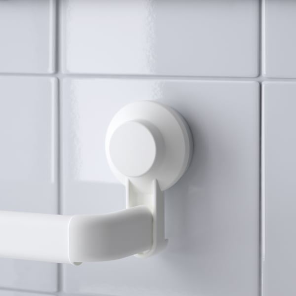 White suction cup mounted on tiled wall, securing a towel bar. Secure, functional, no-damage design.