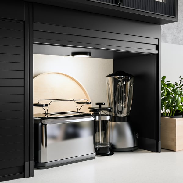 Black TITTEBO appliance garage with silver toaster, cafetière, and blender.