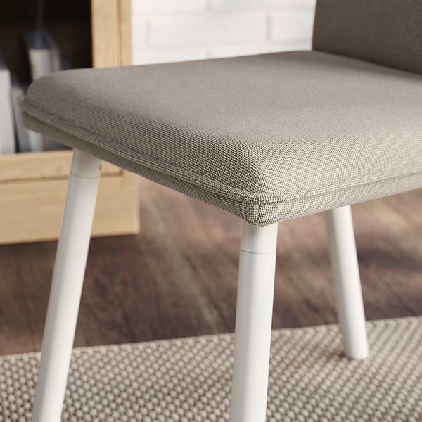 Close-up of TONSTAD chair, grey cushioned seat with white metal legs, stylish and comfortable.