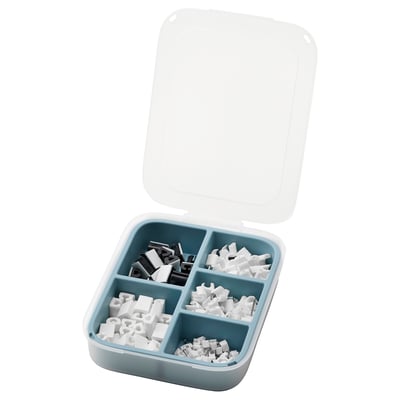 Open blue plastic toolbox with clear lid. Holds white and black plastic fasteners in four compartments.