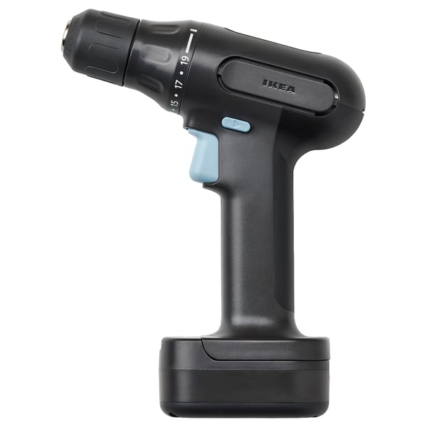 Displays a black ikea TRIXIG cordless drill with a blue switch, standing upright. It has a sleek design with a rubberized handle for grip.