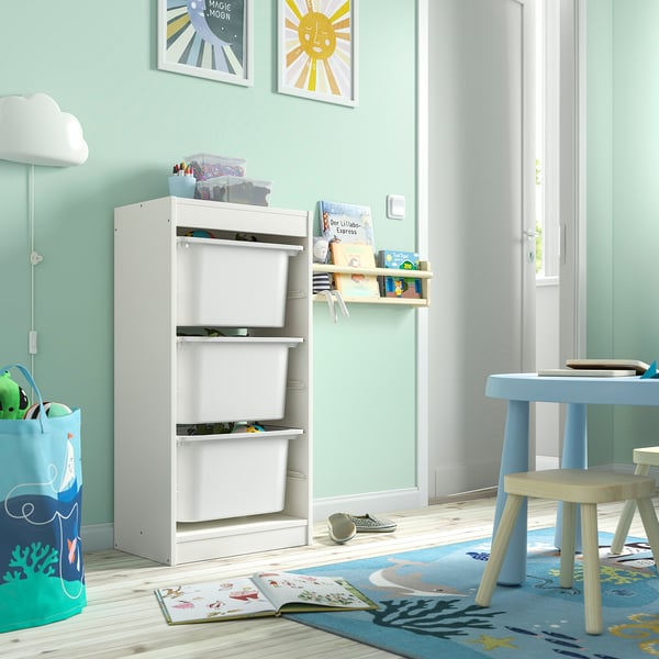 Kids room with TROFAST storage, toy basket, blue table, ocean rug, colourful art.