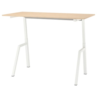 The TROTTEN table is rectangular with a light wood top and white metal legs, configured for height adjustment.