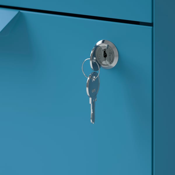 A close-up of a blue metal cabinet with a round keyhole lock and silver keys inserted.