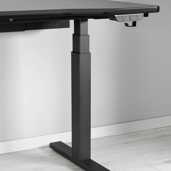 Black adjustable standing desk with control panel, showcasing sturdy build and electric height adjustment.