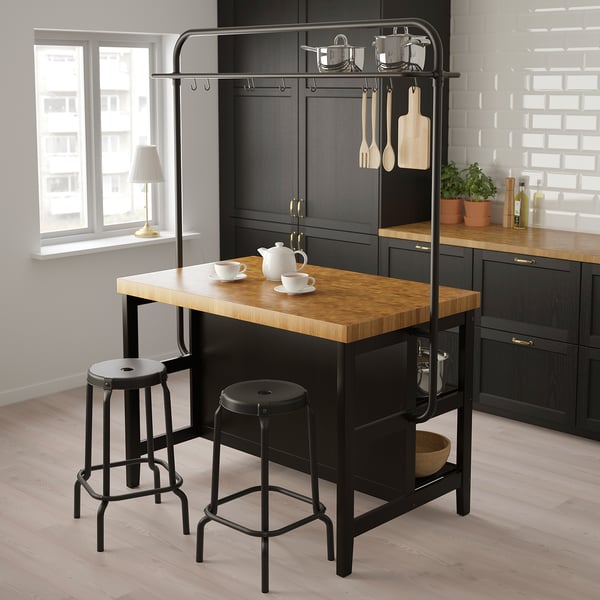 VADHOLMA: black kitchen island with wooden top and two stools. Has hooks for pots and utensils. Smaller than main cabinets.
