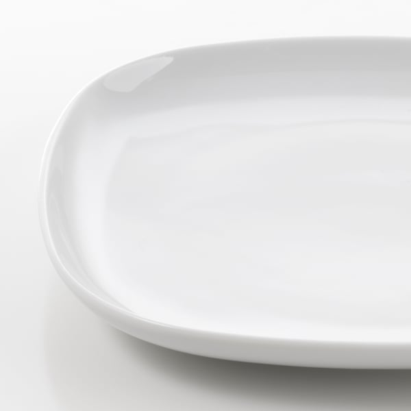 Close-up of a smooth, white porcelain plate with rounded edges. Highlights its sleek, durable surface and polished finish.