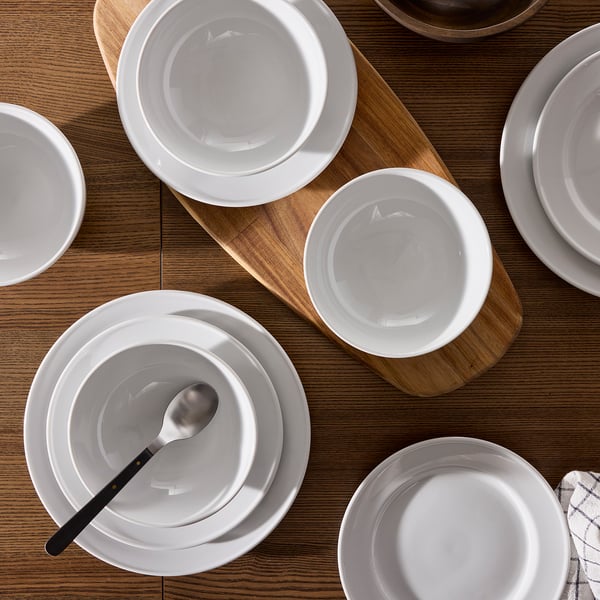 VARDAGEN porcelain dishes; plates & bowls on wood table, stacked with spoon. Elegant, durable, classic.