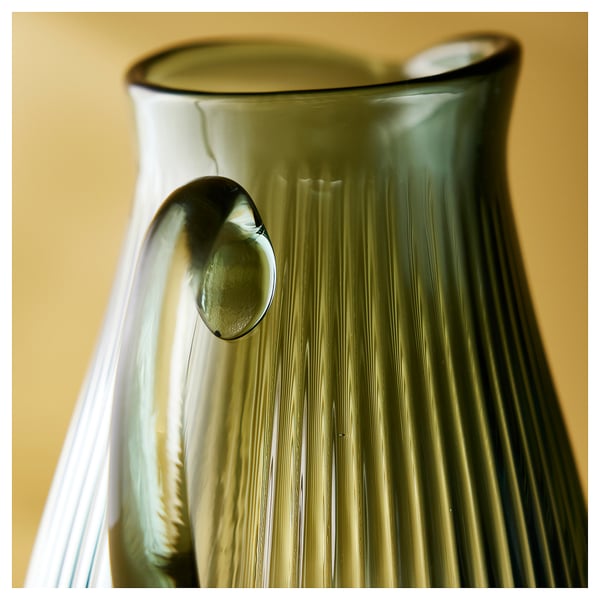 The VARDAGEN, a classic glass jug, stands beautifully. Its clear, ribbed texture and round handle make it elegant for any table.