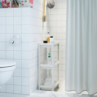 Small bathroom organiser VESKEN fits snugly into tight spaces, holding bottles and toiletries securely.