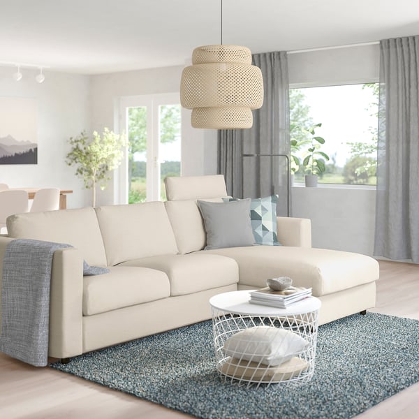 VIMLE sofa, blue pillows, coffee table, rug, lamps, spacious.