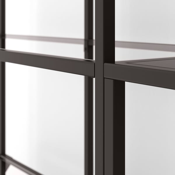 Modern glass & metal bookshelf with steel frame & clear shelves.