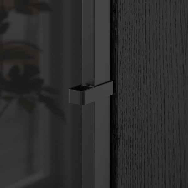 Close-up of modern, dark BILLY bookcase door with sleek handle, showcasing quality materials and design.