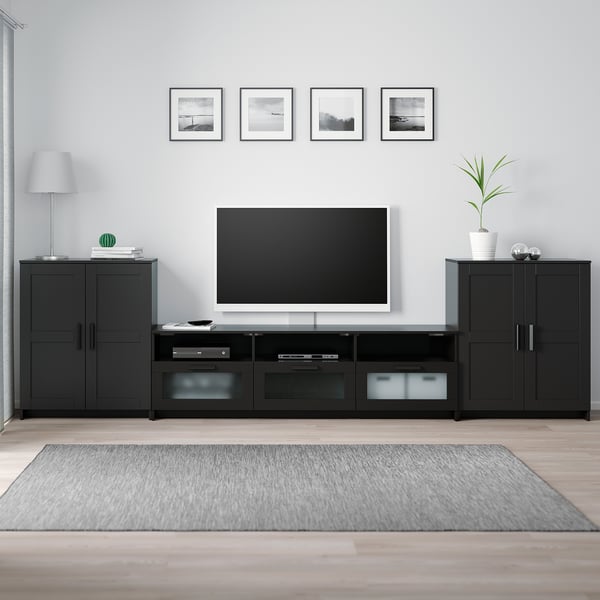 Minimalist living room: BRIMNES tv stand, flat-screen tv, decor, lamp, grey rug, artwork.