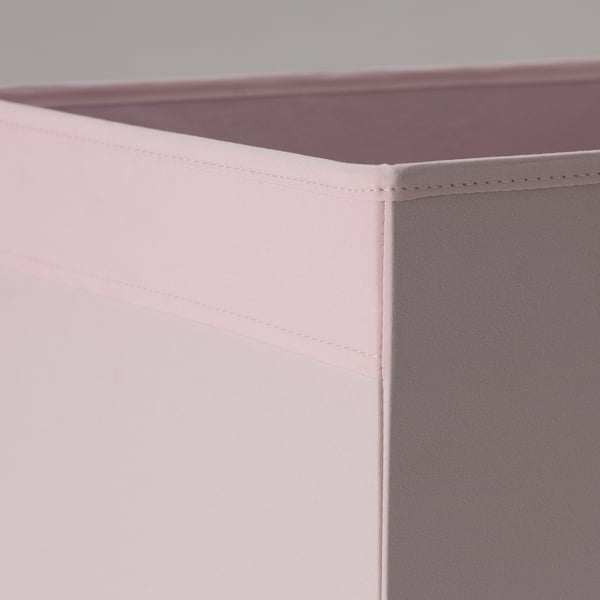 Close-up of pink fabric storage box showing sturdy, neatly stitched seams and quality fabric.