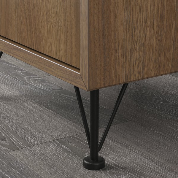 Wooden furniture with sleek, black metal legs and adjustable bases.
