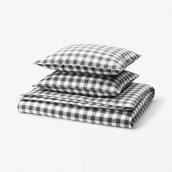 Folded black and white chequered duvet set, featuring classic gingham pattern, neatly stacked.