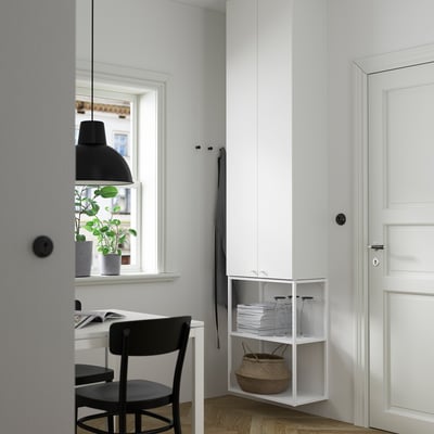 ENHET white storage cabinet with shelves, small, modern design, fit corner, next to desk, door, and window.