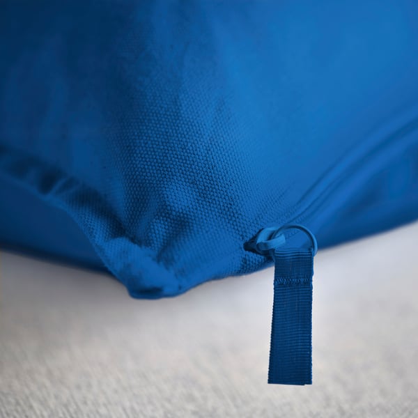 Bright blue cushion with quality zip detail, showcasing durable cotton material.