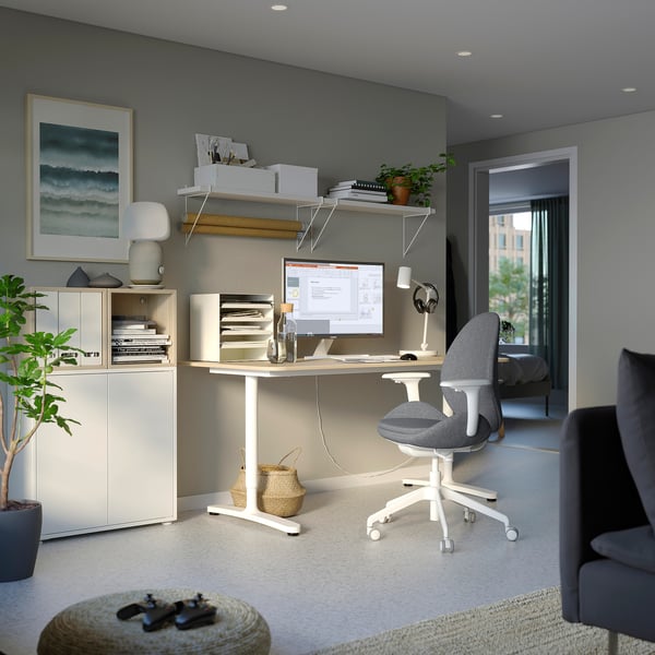 Home office setup with HATTEFJÄLL chair, white desk, shelves, computer, and plants.