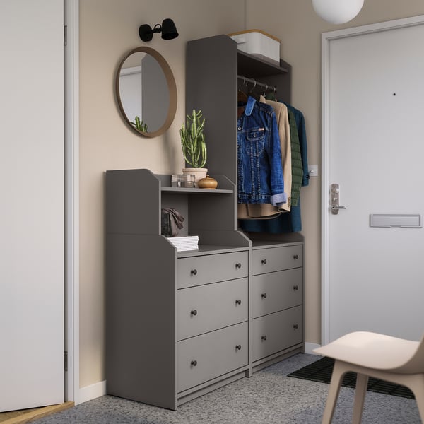 Modern entryway setup: grey HAUGA storage units, mirror, coats, and plants.