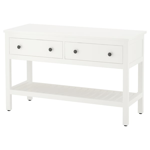 A white HEMNES console table. It has three drawers with silver knobs and an open shelf. The design is simple and functional.