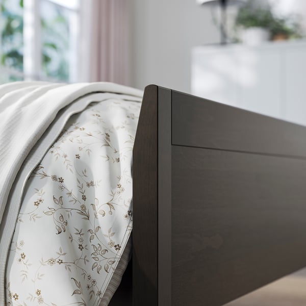 IDANÄS wooden headboard, simple design, dark wood, white flowers sheet.