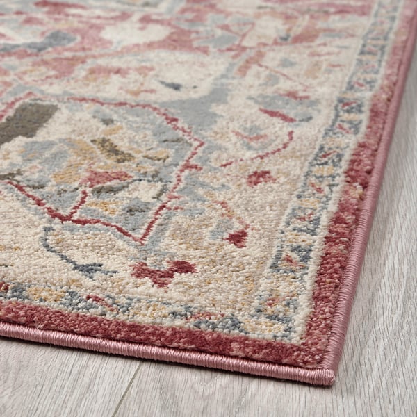 Soft, durable rug with classic oriental patterns and pastel colours on a light wooden floor.