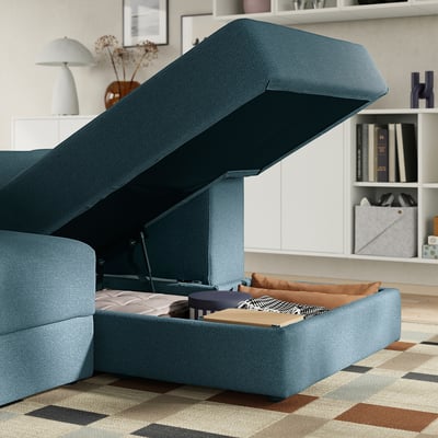 Blue modular sofa with open storage. Soft cushions and easy-access under-seat space.