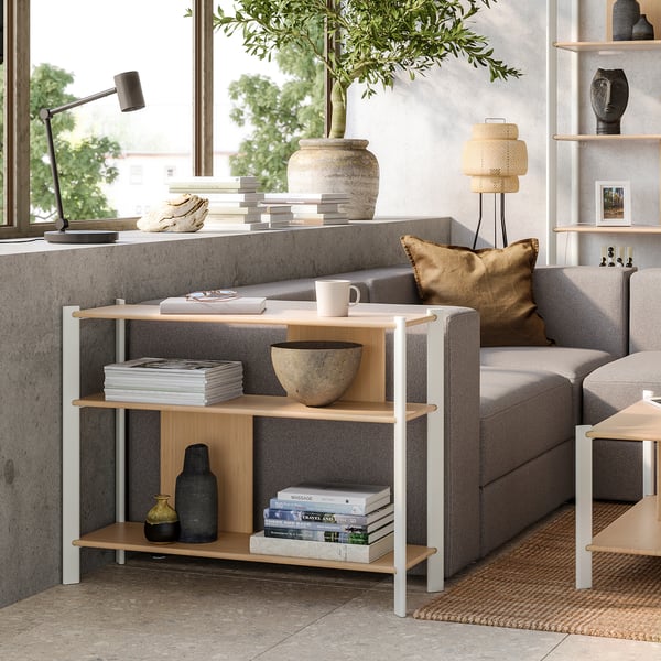 Minimalist living room with JÄTTESTA bamboo shelf, grey sofa, & large window.