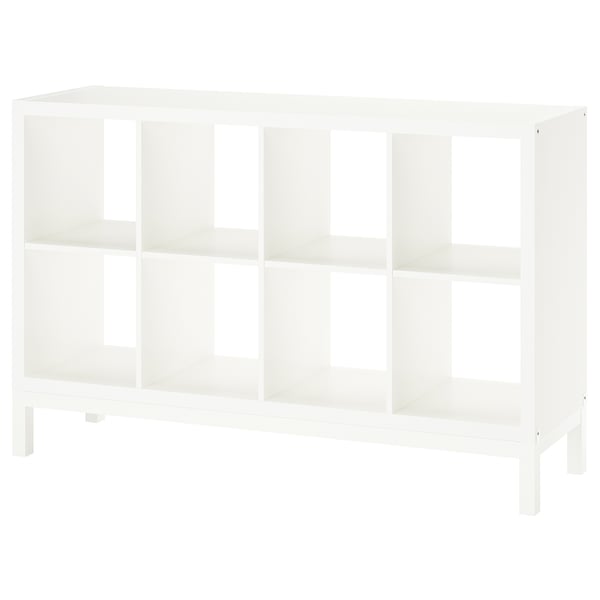 A white KALLAX shelving unit with open cubes and an airy underframe design.