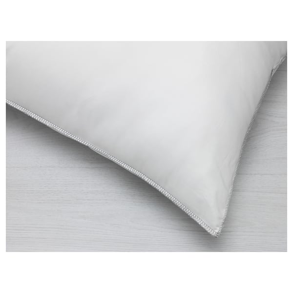 Closeup of quality microfiber pillow showing smooth fabric and stitching detail.