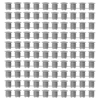 Grid of grey KOMPLEMENT polyethylene plastic cover caps, uniformly arranged, cylindrical shape with ridged design.