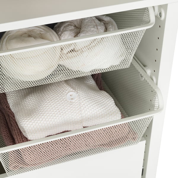 Mesh baskets in cabinet, with clothes neatly folded. Allows air circulation, keeping items fresh and visible.