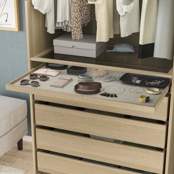 Wooden drawer unit with pull-out tray displaying accessories, part of IKEA KOMPLEMENT series.