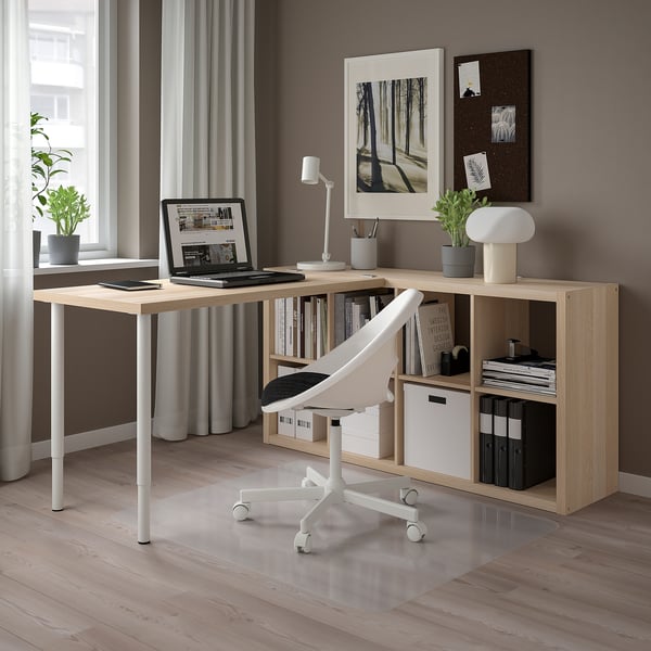 Modern home office with LAGKAPTEN light wood desk & white chair; well-organized with computer, lamp, books, and plants.