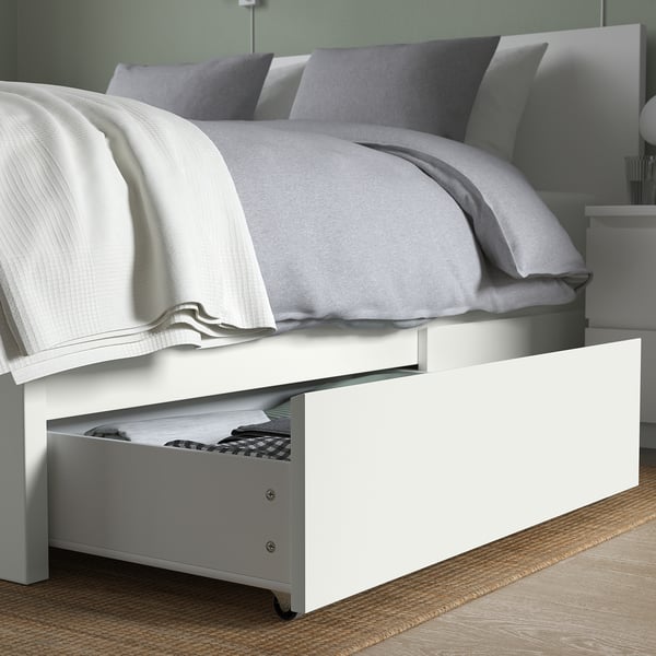 Bed with white under-frame storage, showing open drawer.