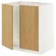 A white METOD cabinet with wooden doors, featuring a sturdy frame and snap-on hinges, designed for a built-in oven or sink.