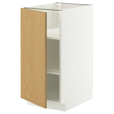 A white METOD kitchen cabinet with a light oak door, featuring a minimalist design and adjustable shelves.
