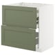 Green and white kitchen cabinet with drawers, modern design.