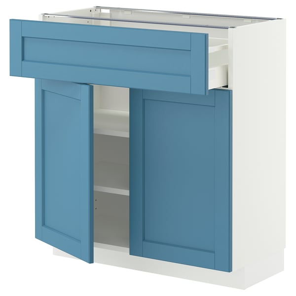 A blue and white METOD kitchen cabinet with a drawer and shelves.