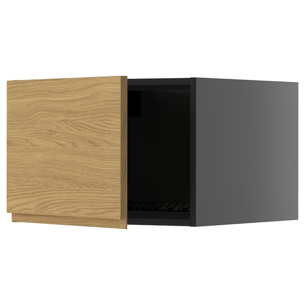 Modern kitchen cabinet with oak-textured door, dark interior.