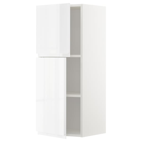 A white METOD kitchen cabinet with two adjustable shelves and integrated handles. Modern and minimalist, it a high gloss finish.