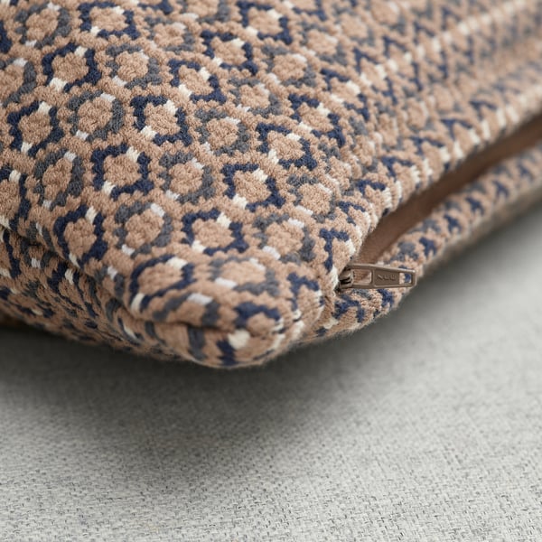 Close-up of coarsely-textured, yarn-dyed cushion cover with zip, showcasing intricate grey-beige/anthracite pattern.