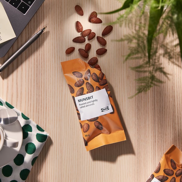 IKEA almonds on desk with laptop, pen, plant