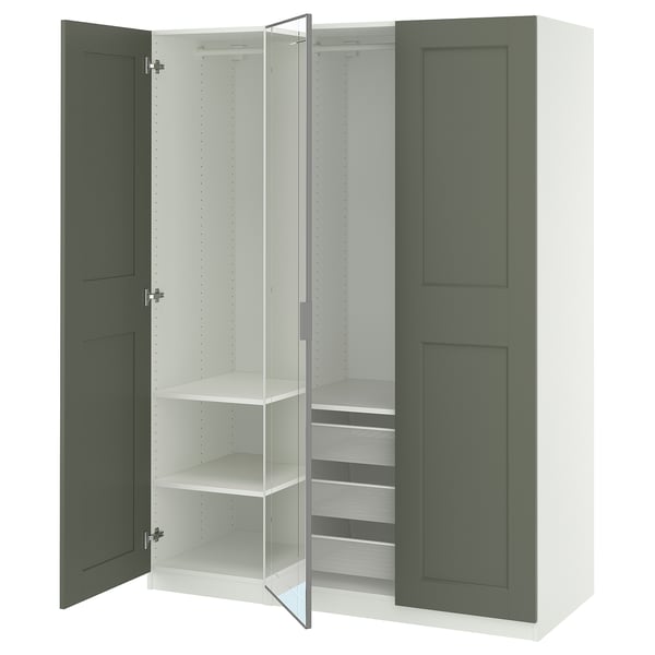 An open PAX wardrobe with green doors and shelves.