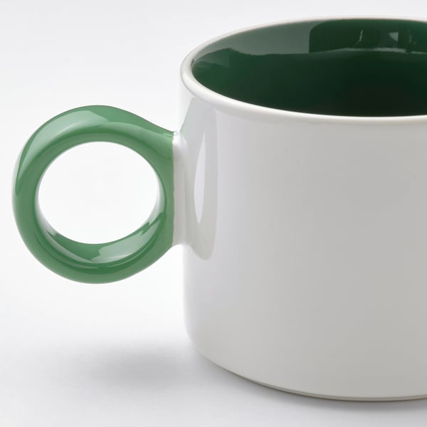 Green-handled mug, white, glossy inside.