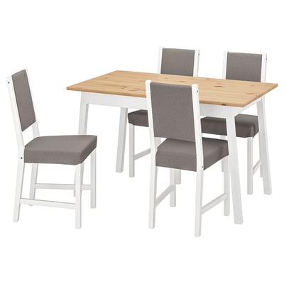 A white and wood dining set named PINNTORP. It includes a square wooden table and four matching chairs with grey cushions.