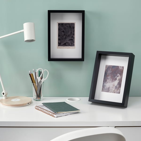 Desk with art frames, lamp, and stationery. Frames can stand or hang, with acid-free mounts.